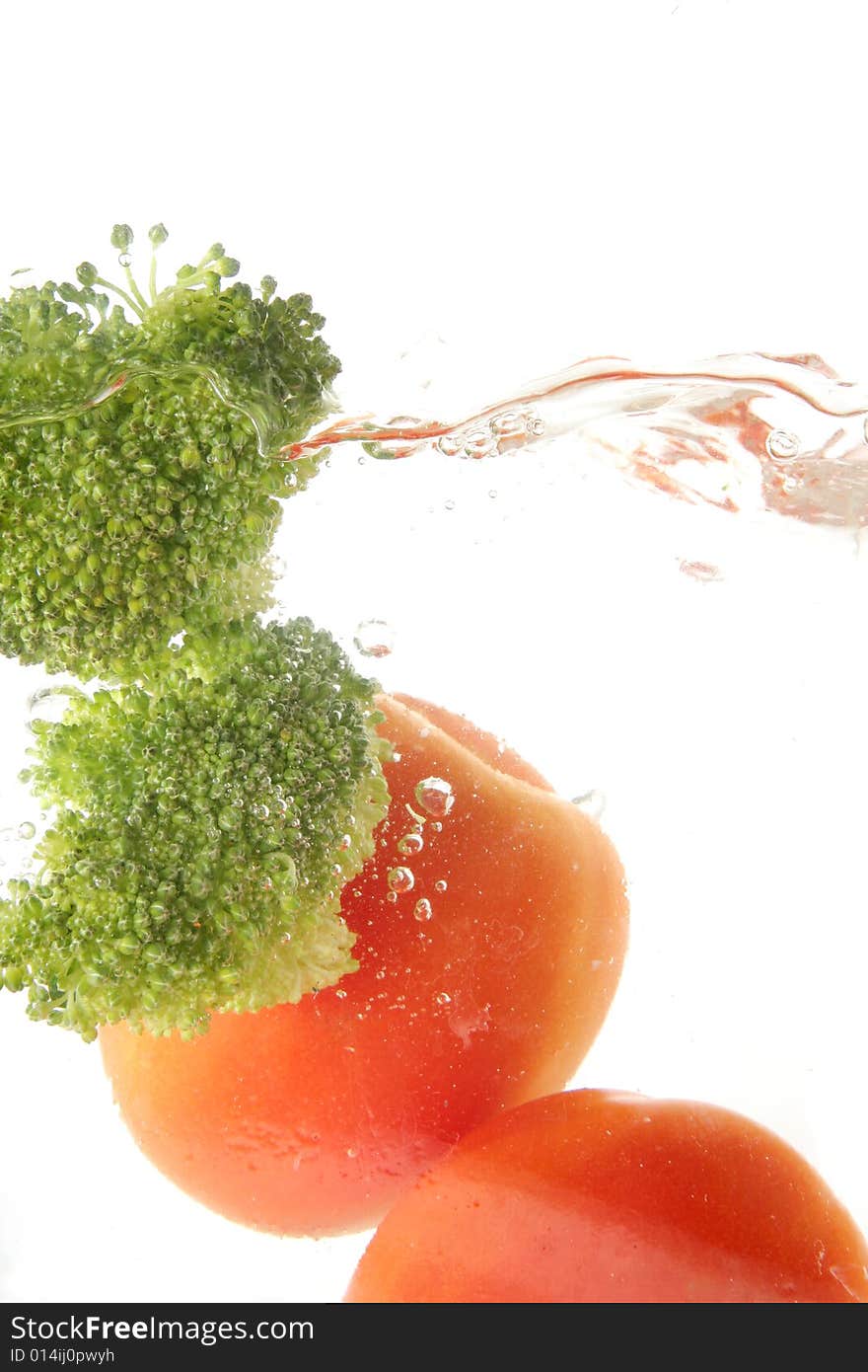 Tomato and broccoli vegetables splash