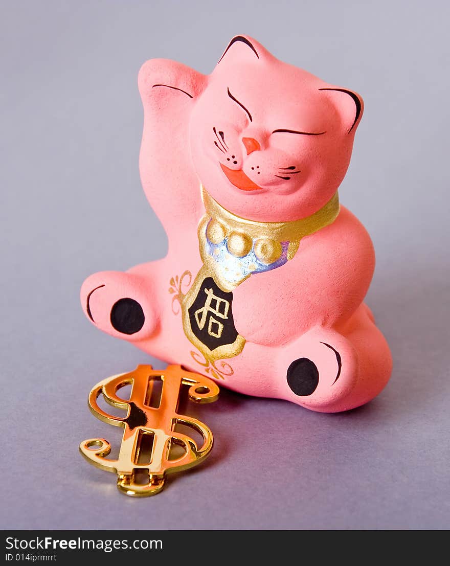 Maneki neko cat with golden dollar sign. Maneki neko cat with golden dollar sign