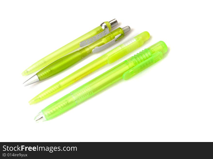 Four green plastic pens