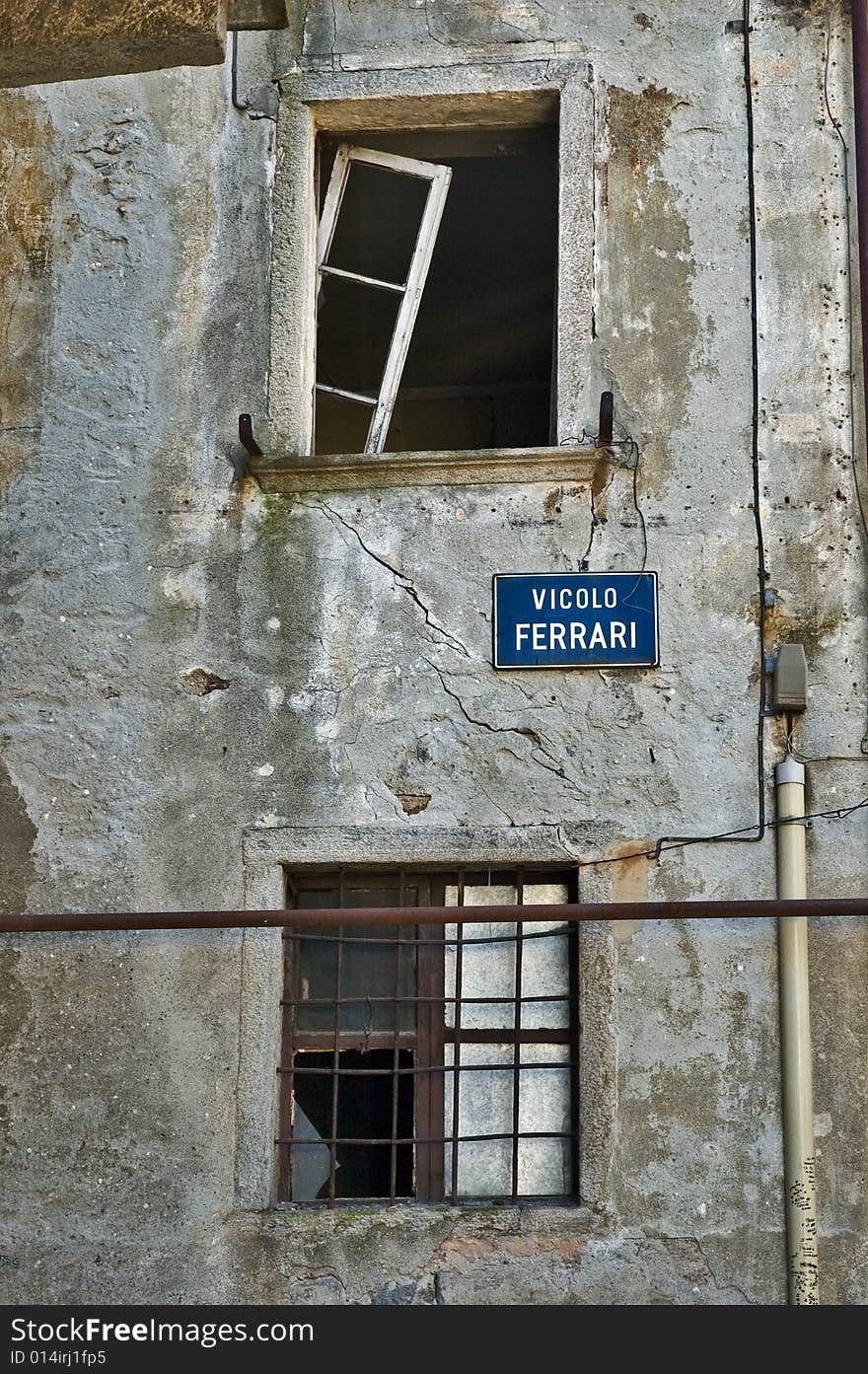 Dilapidated italian house windows with rotting walls and broken windowpanes. Dilapidated italian house windows with rotting walls and broken windowpanes