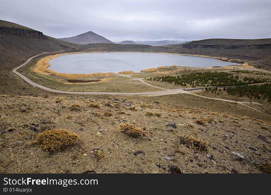 Lake in the crater of a volcano, with the road inside.