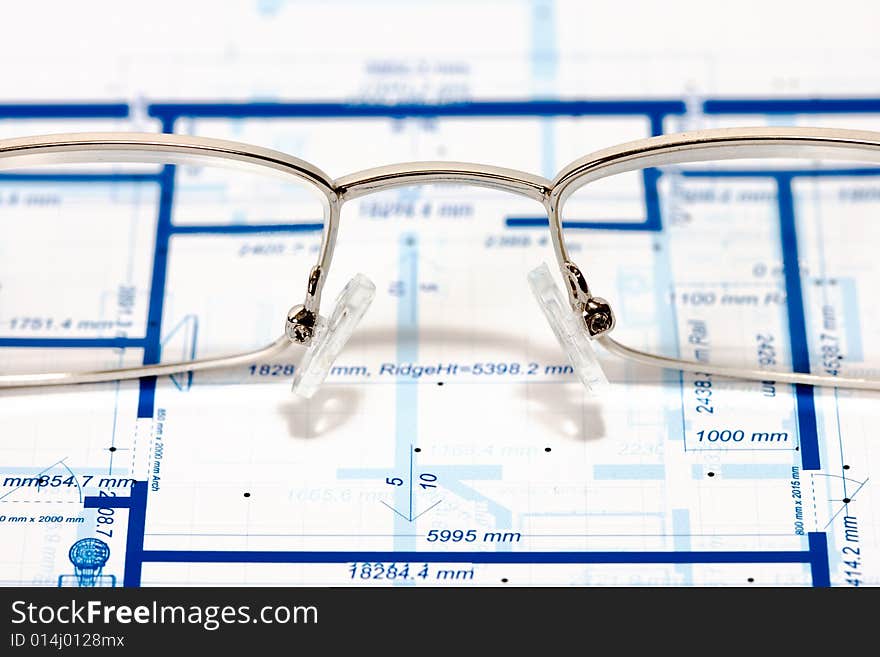 Blueprint for a house and eyeglasses