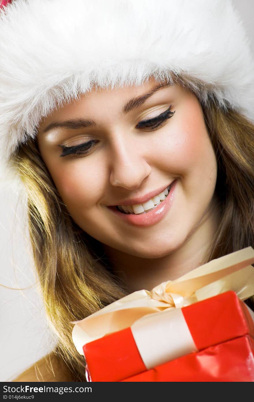 Winter portrait of a beautiful young smiling woman with a christmas cap. Winter portrait of a beautiful young smiling woman with a christmas cap