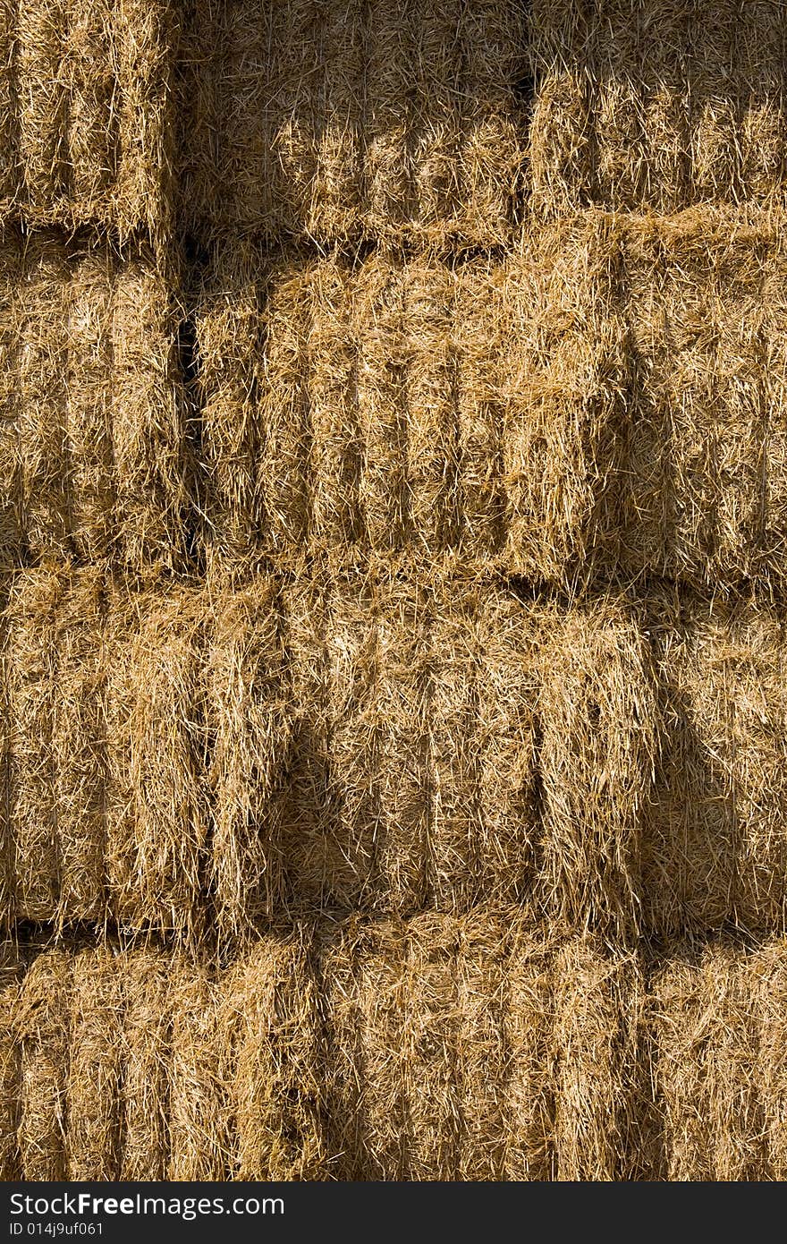 Straw bales stocked on storage place.