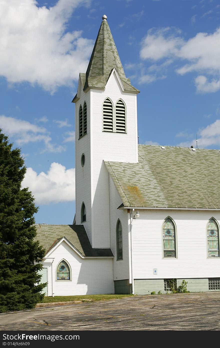 This is a church in rural midwest with steeple and looking a little aged. This is a church in rural midwest with steeple and looking a little aged.