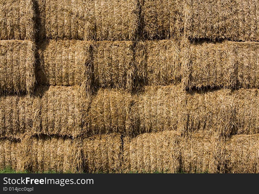 Straw bales stocked on storage place.