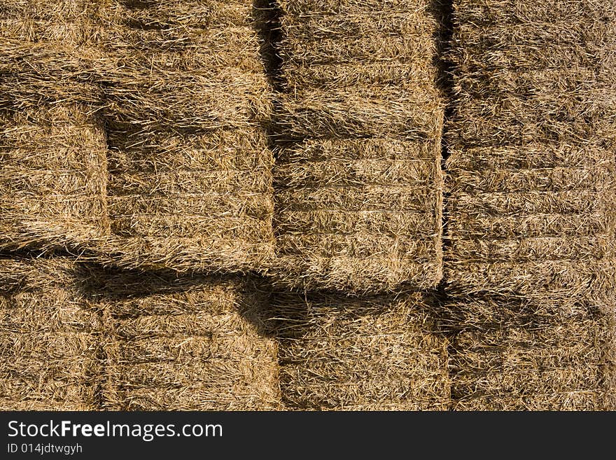 Straw bales stocked on storage place.