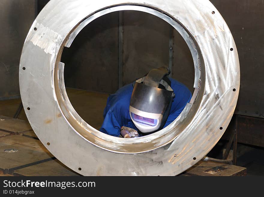 A metal welder busy at work. A metal welder busy at work