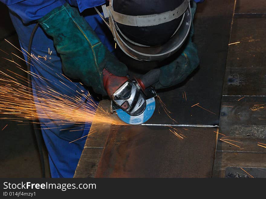 A metal welder busy at work. A metal welder busy at work