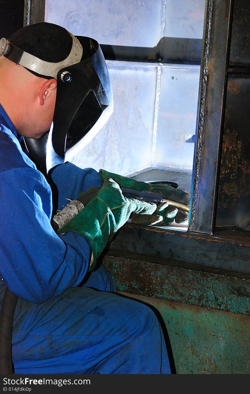 A metal welder busy at work. A metal welder busy at work