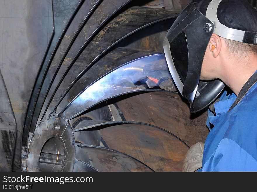 A metal welder busy at work. A metal welder busy at work