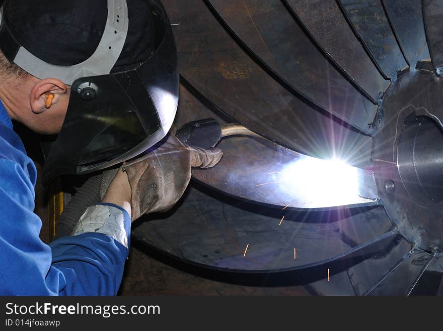 A metal welder busy at work. A metal welder busy at work