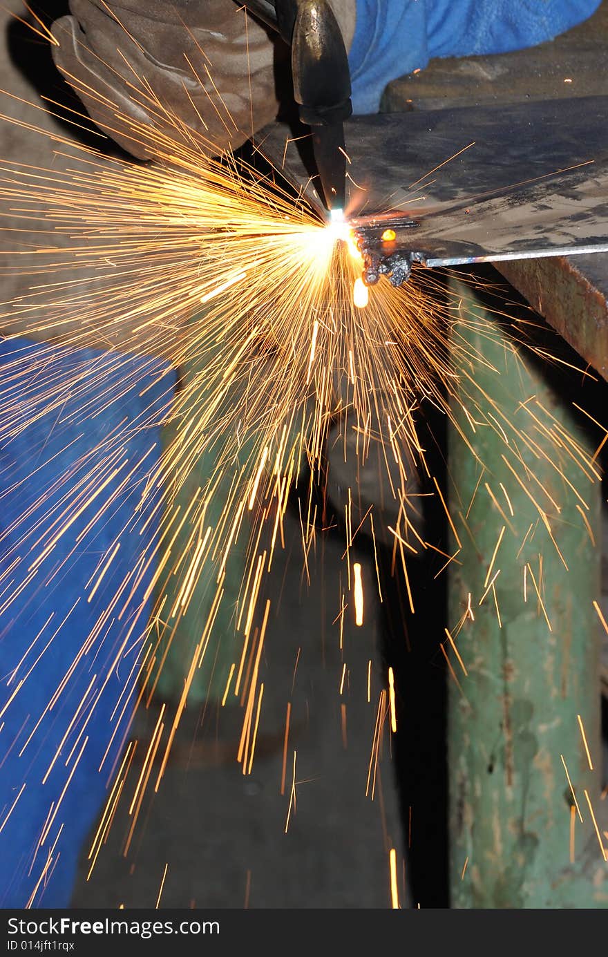 A metal welder busy at work. A metal welder busy at work