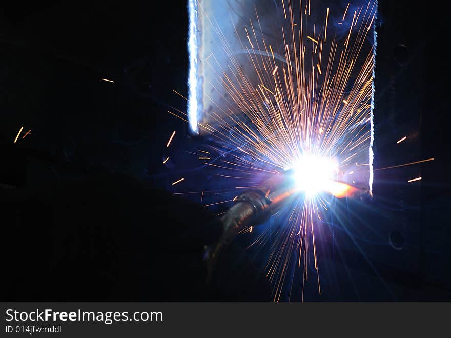 A metal welder busy at work. A metal welder busy at work