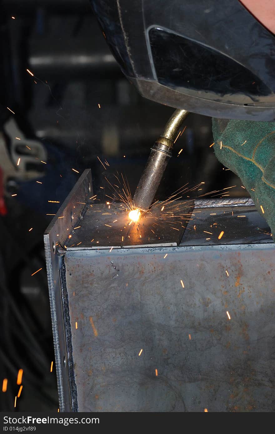 A metal welder busy at work. A metal welder busy at work