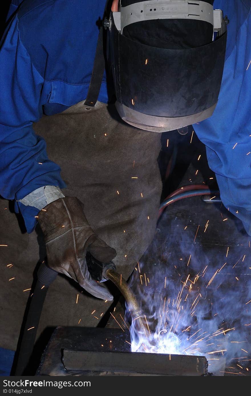 A metal welder busy at work. A metal welder busy at work