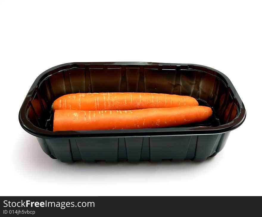 Wrapped carrot in a black plastic box isolated on a white background.