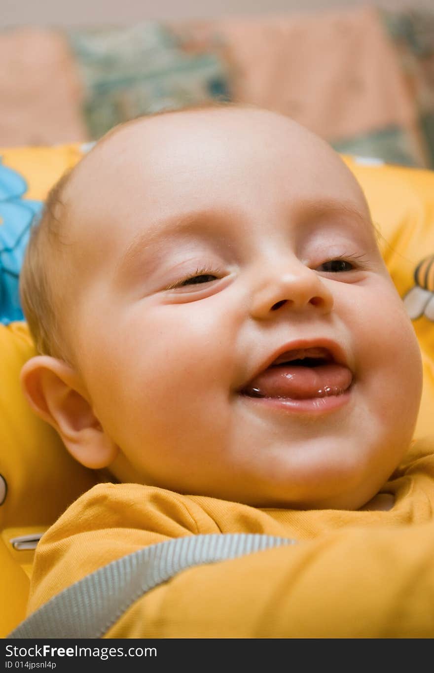 Little baby girl, looking very happy, smiling in a dining chair. Little baby girl, looking very happy, smiling in a dining chair