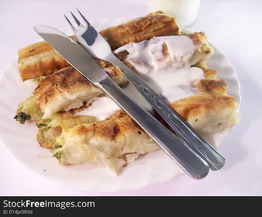 Pie covered with milk and eating tools