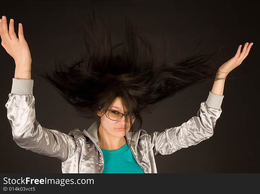 Beautiful girl shaking her hair isolated on black background