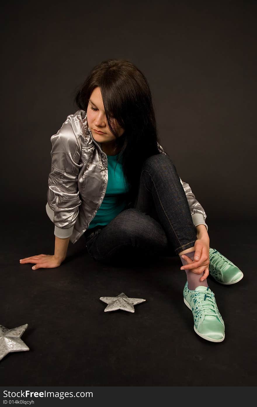 Young girl in casual outfit isolated on black background