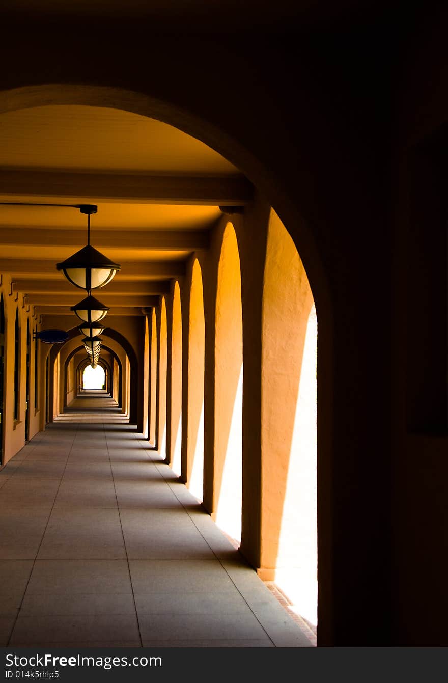 Spanish Style Arched Corridor framed by stucco walls