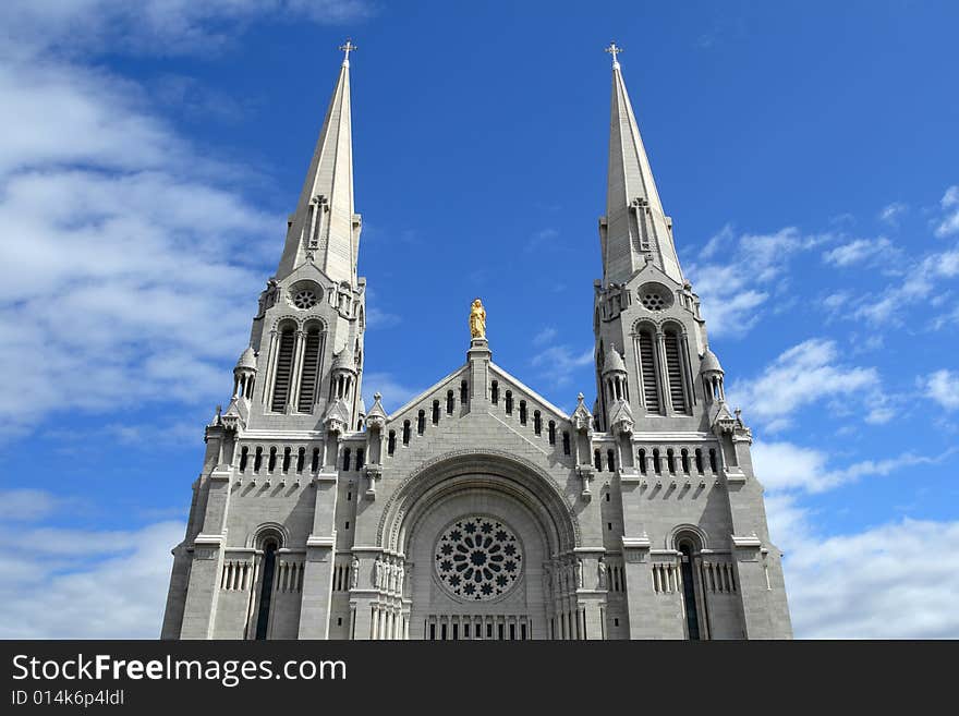 Catholic church against blue sky with clouds.