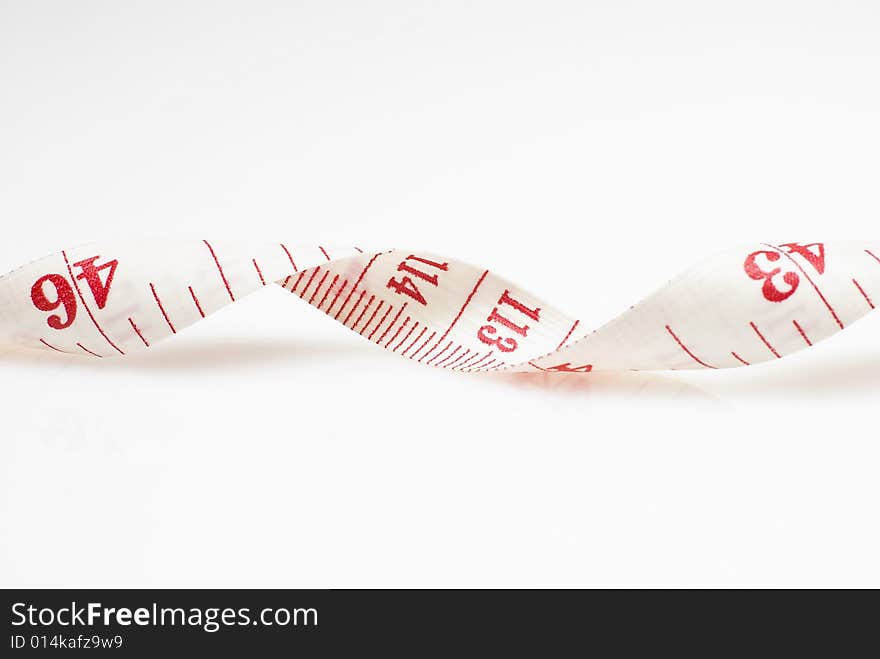 Studio shot of measuring tape against white background. Studio shot of measuring tape against white background