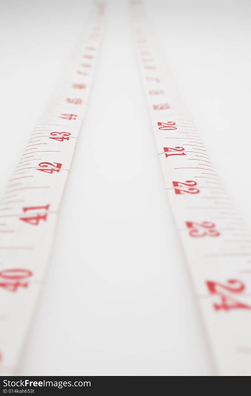 Studio shot of measuring tape against white background. Studio shot of measuring tape against white background