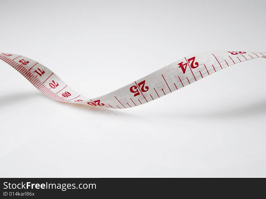 Studio shot of measuring tape against white background. Studio shot of measuring tape against white background