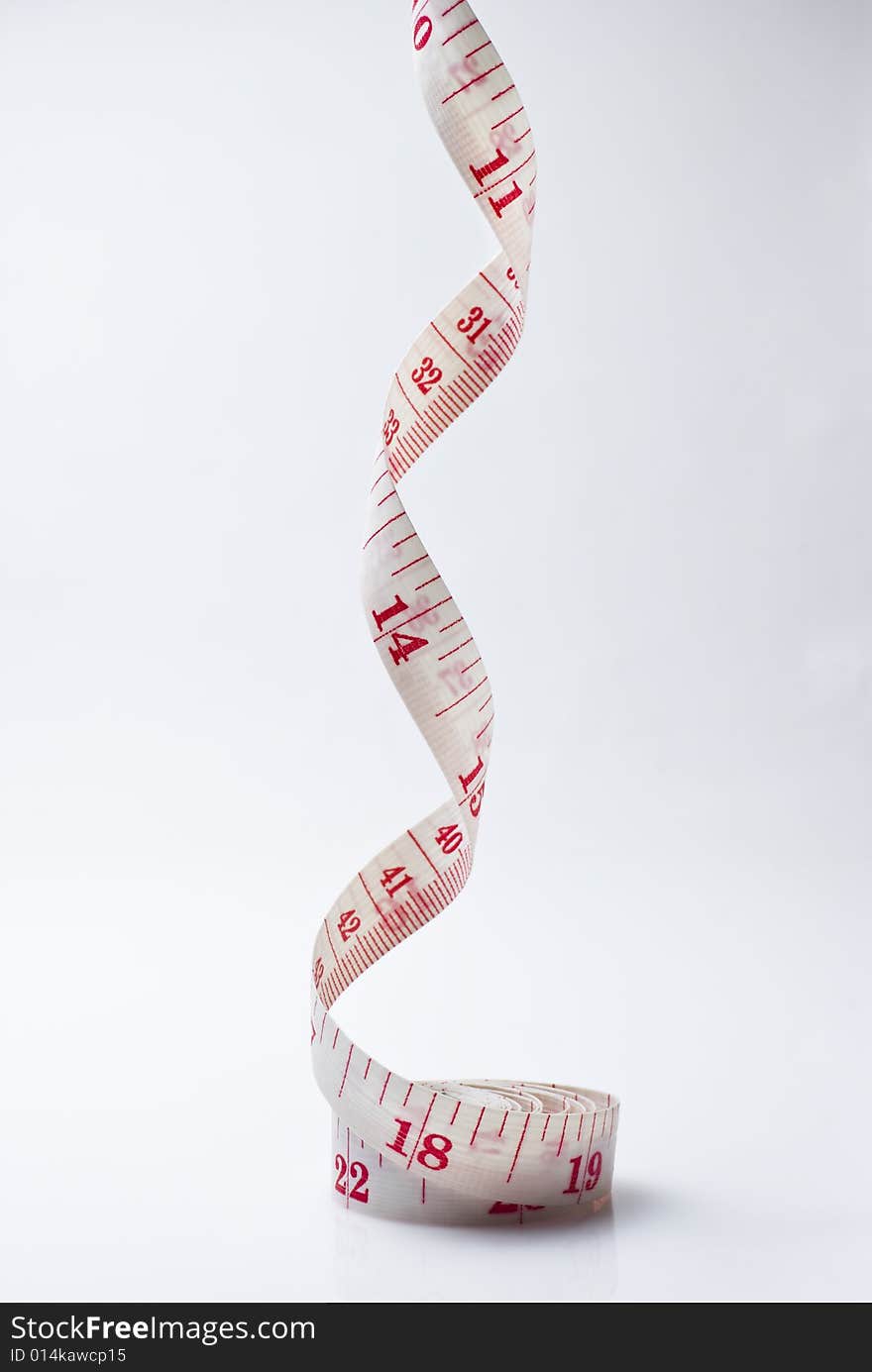 Studio shot of measuring tape against white background. Studio shot of measuring tape against white background