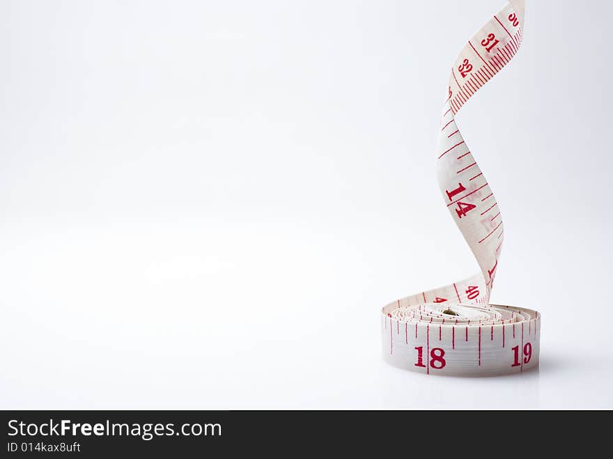 Studio shot of measuring tape against white background. Studio shot of measuring tape against white background