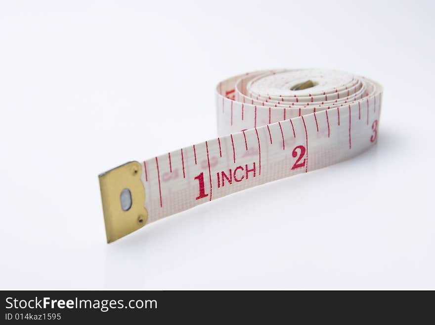 Studio shot of measuring tape against white background. Studio shot of measuring tape against white background