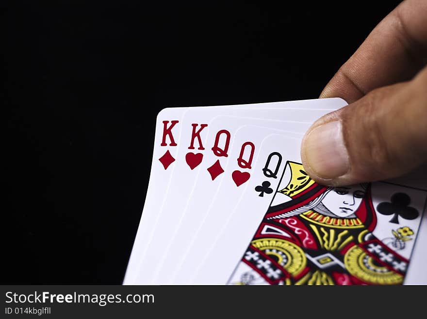 Three Kings and three Queens held by hand against black background. Three Kings and three Queens held by hand against black background