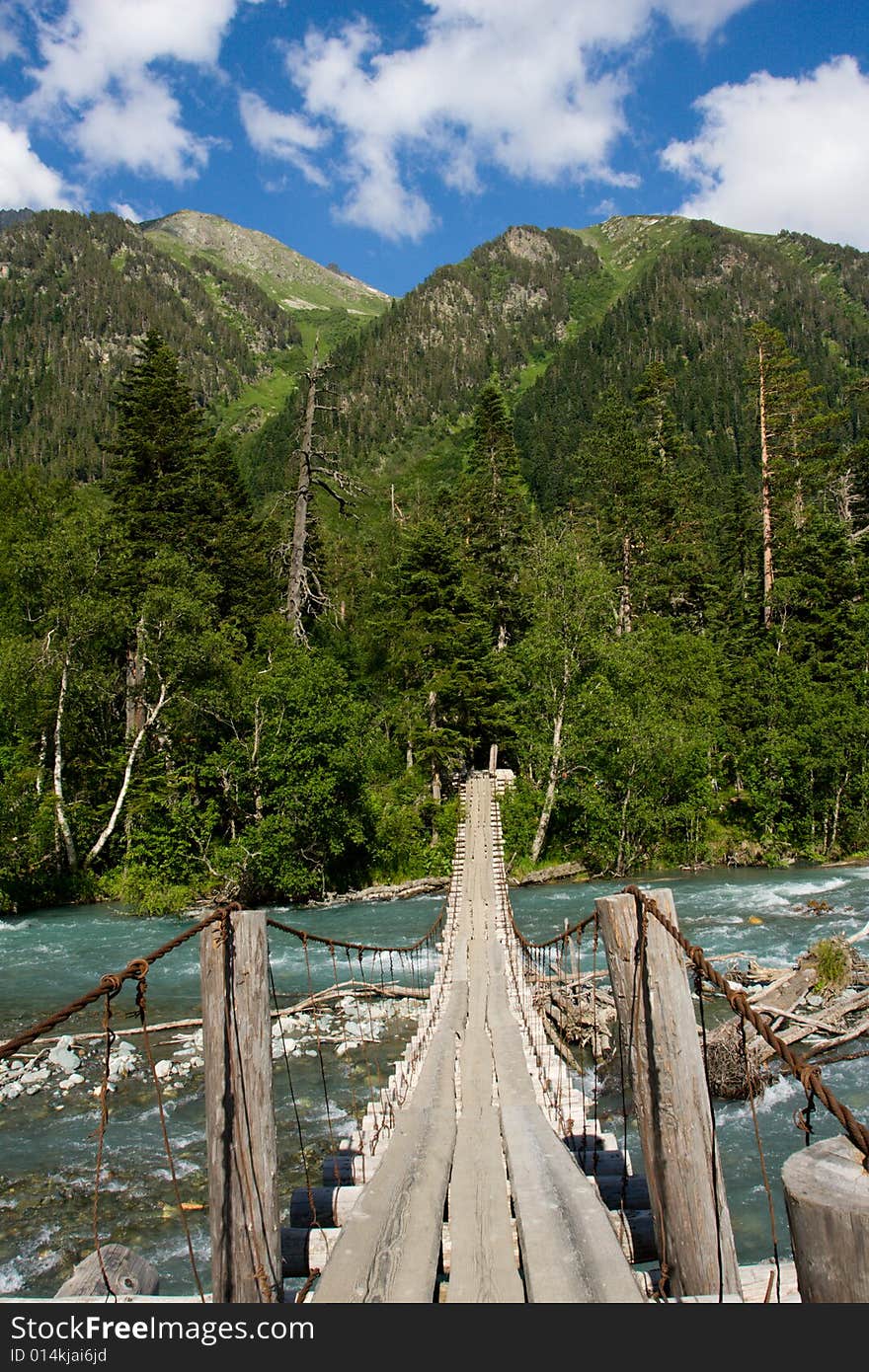 Suspension bridge over mountain river. Suspension bridge over mountain river