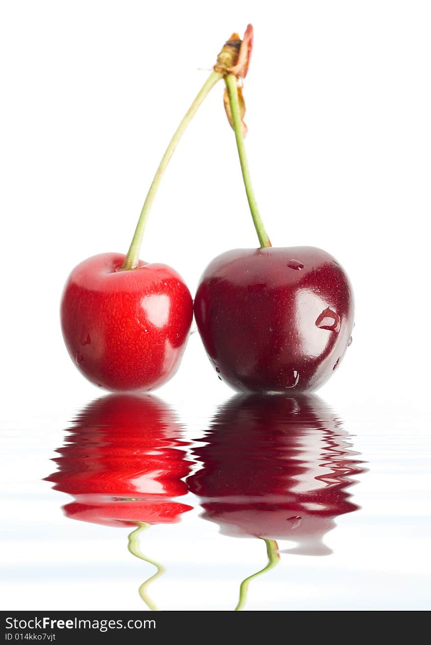 An image of two red berries in a water. An image of two red berries in a water