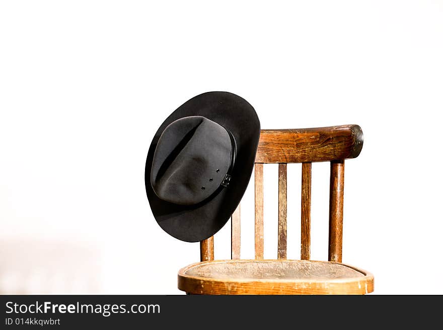 An image of wooden chair with hat