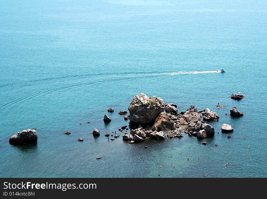 Picture of gulf nearby Sudak on Crimea Ukraine, with rocks and motor boat