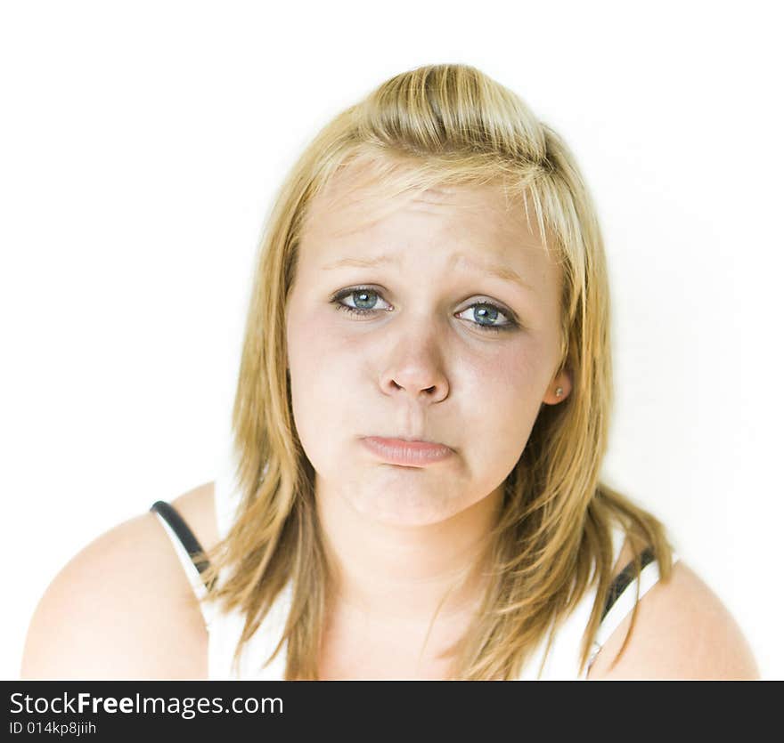 Young teenage girl looking sad. Isolated on white background. Young teenage girl looking sad. Isolated on white background