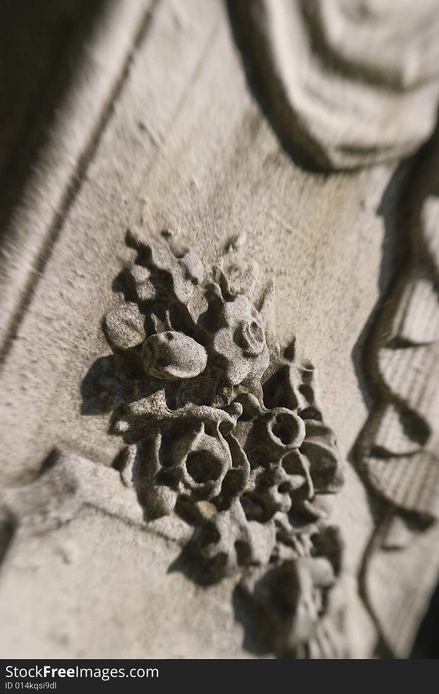 A selective-focus detail of a floral spray and drapery on an early 19th-century grave marker in historic Harrisburg Cemetary (Pennsylvania). A selective-focus detail of a floral spray and drapery on an early 19th-century grave marker in historic Harrisburg Cemetary (Pennsylvania)