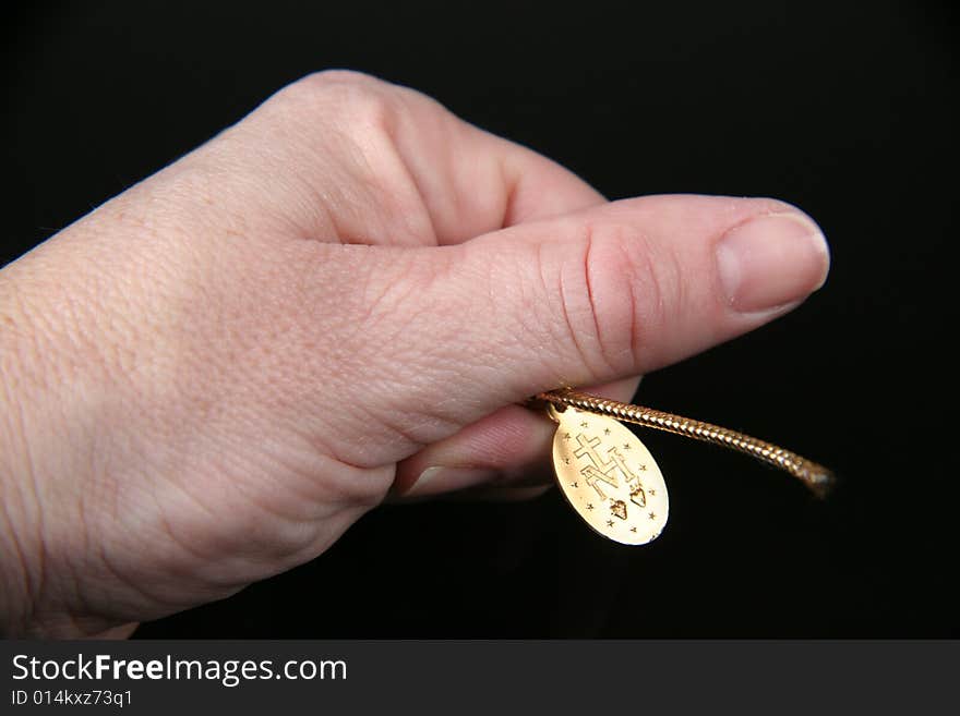 A close up view of praying hands over black background