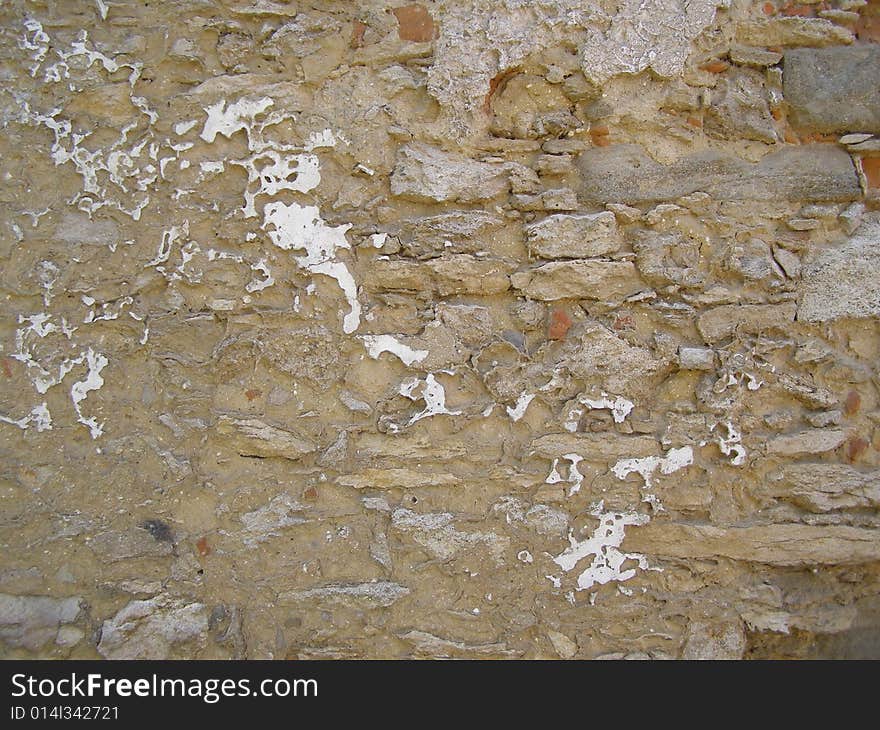 An old shabby stone wall. An old shabby stone wall