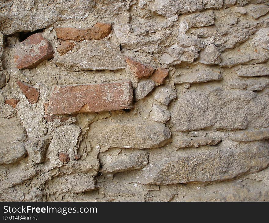 An old shabby stone wall. An old shabby stone wall