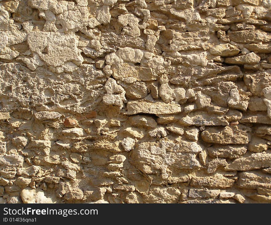 An old shabby stone wall. An old shabby stone wall