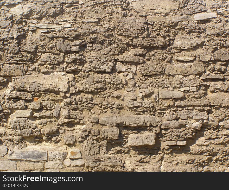 An old shabby stone wall. An old shabby stone wall