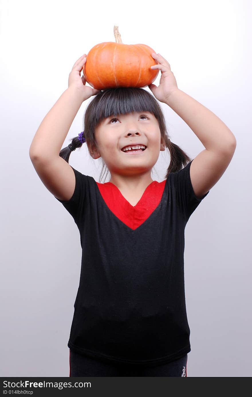 Asia girl smiling with  pumpkin on white background. Asia girl smiling with  pumpkin on white background