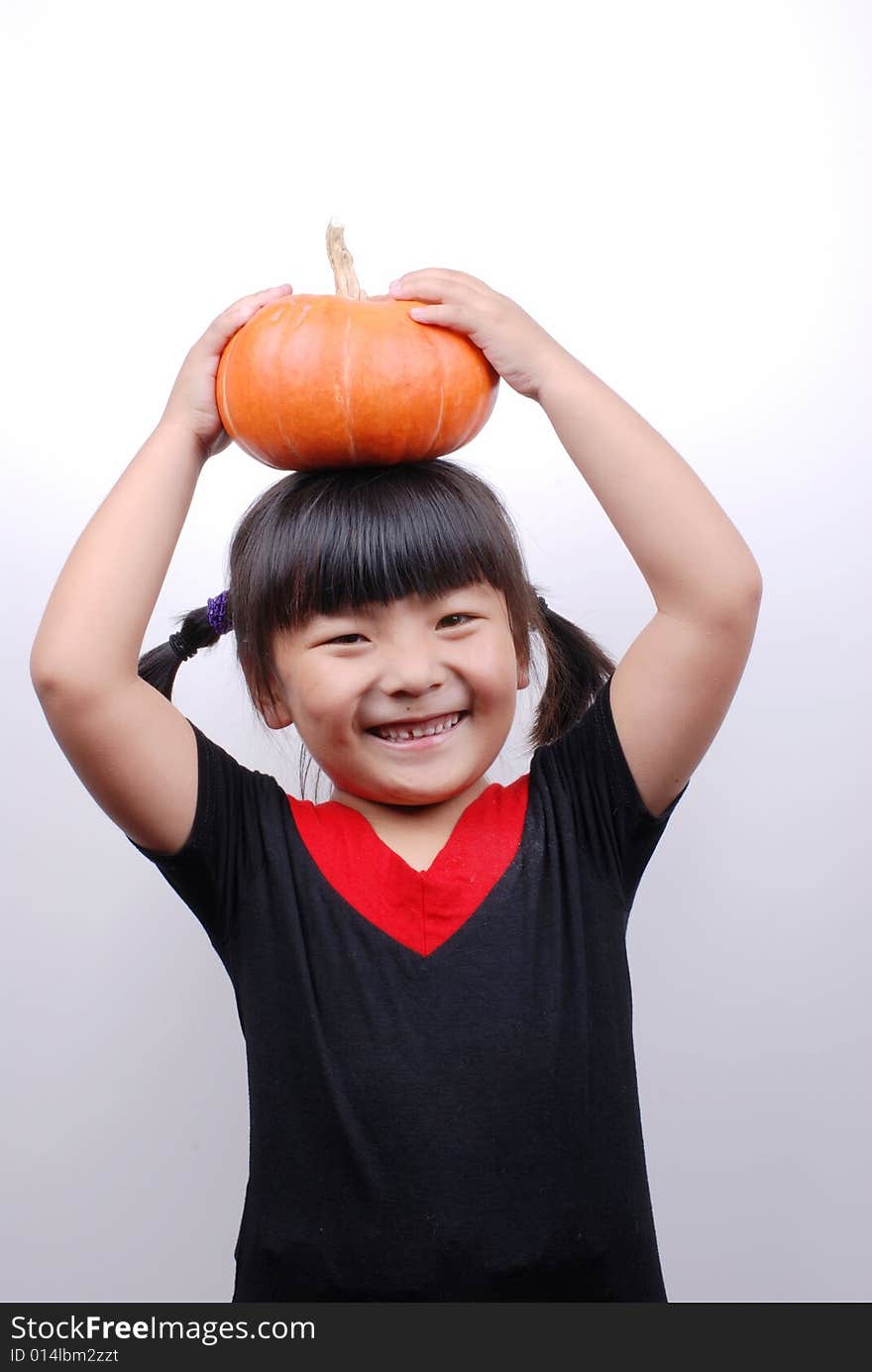 Asia girl shy and smiling with  pumpkin on white background. Asia girl shy and smiling with  pumpkin on white background