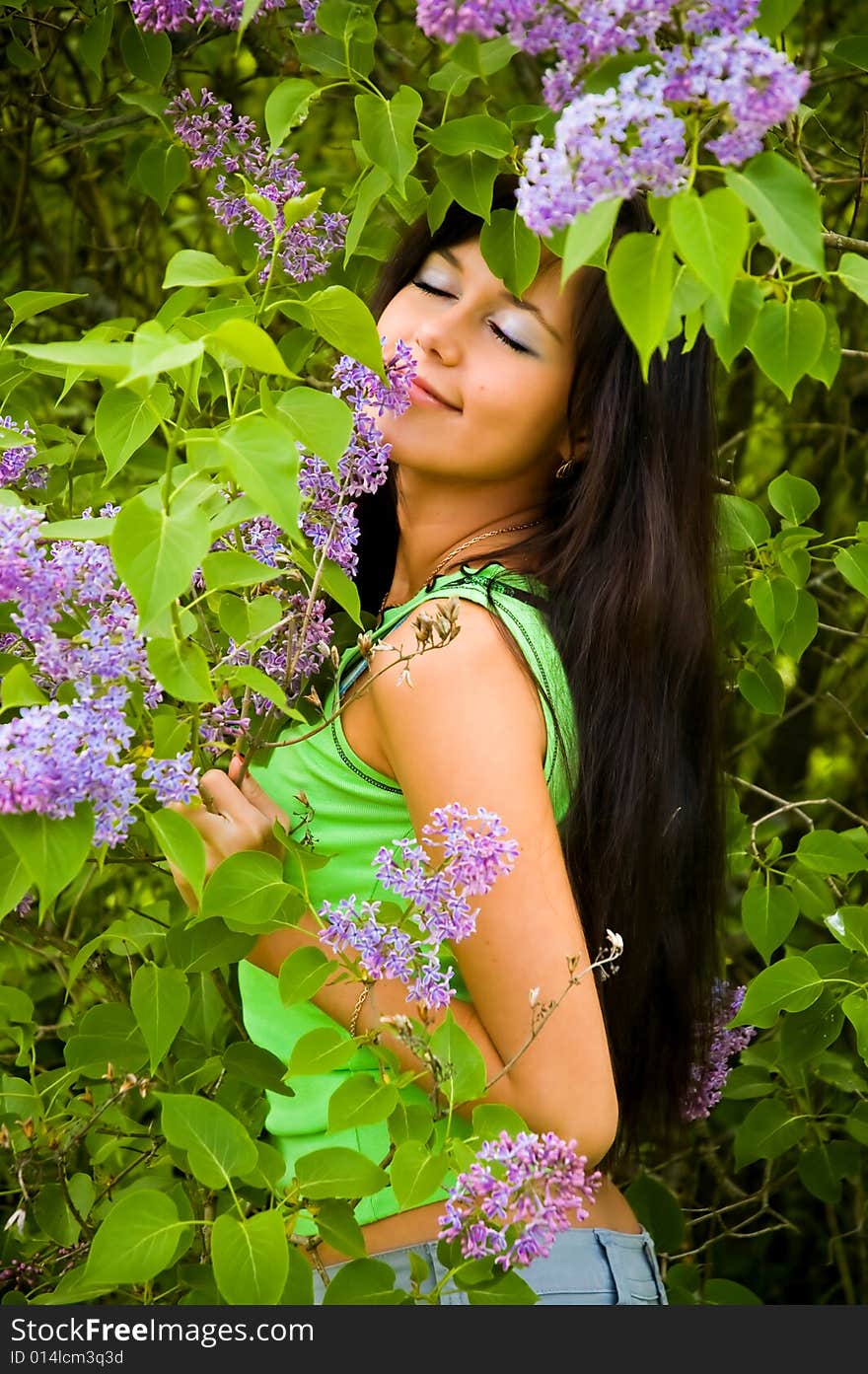 The  girl and blossoming lilac