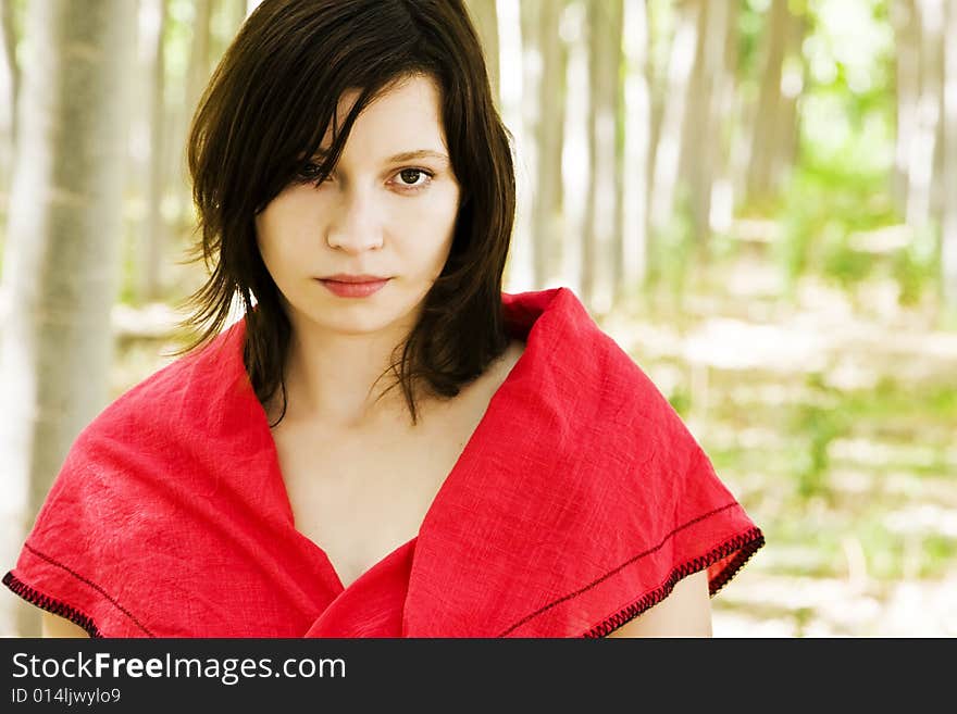 Beautiful woman staring at camera in a forest. Beautiful woman staring at camera in a forest.