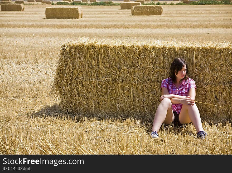 Young woman in haystack